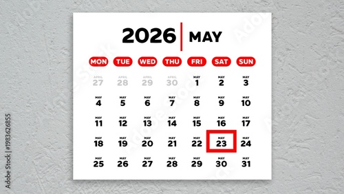 The date May 23rd marked with a red cursor on a wall calendar 2026