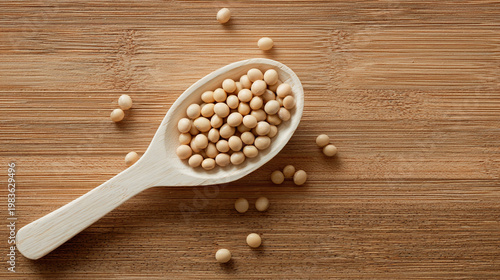 A rustic wooden spoon overflows with golden soybeans resting on a textured cutting board surrounded by scattered beans on burlap