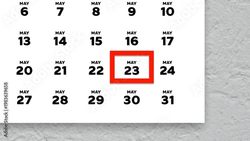 Close-up of the date May 23rd marked with a red cursor on the wall calendar 2026