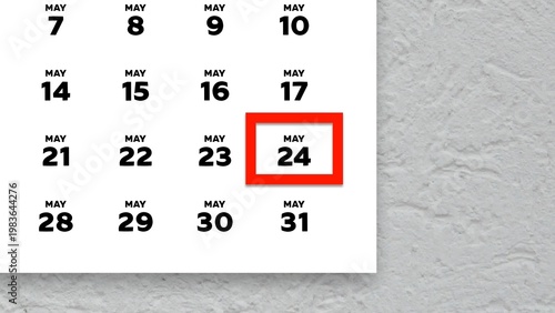 Close-up of the date May 24th marked with a red cursor on the wall calendar 2026