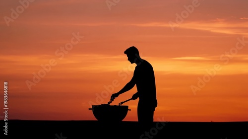 Man Cooks at Barbecue During Sunset by the Outdoor Grill Near Open Space in W...