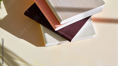 Stack of Notebooks on a Light Surface With Soft Shadows in a Well-Lit Space