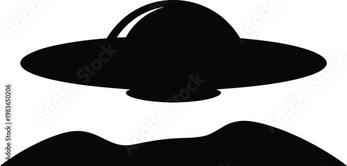 Black silhouette of a flying saucer hovering over rolling hills alien spaceship