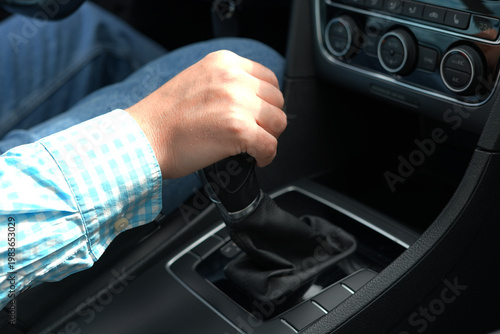 Photos Hand shifting manual gear stick in car close up driver control