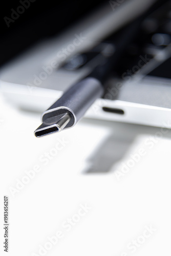 USB Type C cable connector near laptop port in close up view