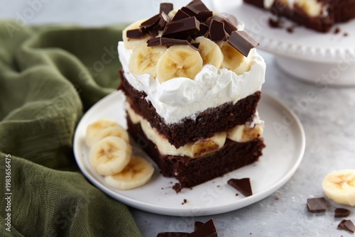 Layered Dessert With Chocolate, Banana, and Whipped Cream on a White Plate