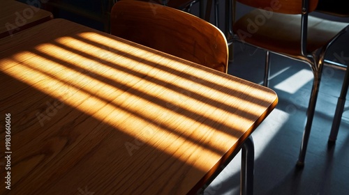 Sunlight Creates Patterns on a Wooden Desk in an Empty Classroom During After...