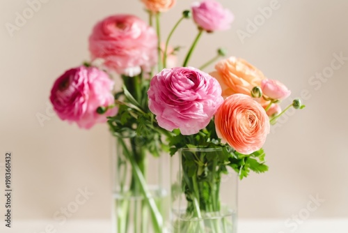 Colorful Flowers in Glass Vases Placed on a Simple Table With Soft Light in a...