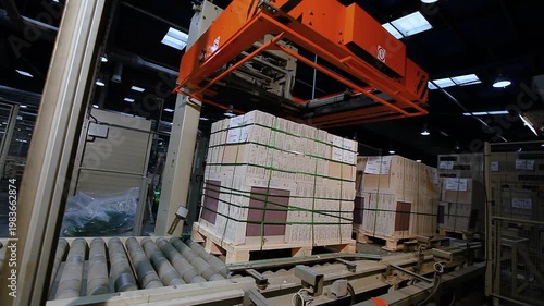 Automatic packing of crates with finished products in a ceramic tile factory. Production of ceramic tiles. Ceramic tile factory. Making ceramic tile.