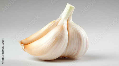 Fresh garlic head and cloves presenting a potent culinary ingredient, essential for adding pungent flavor to various dishes and offering health benefits