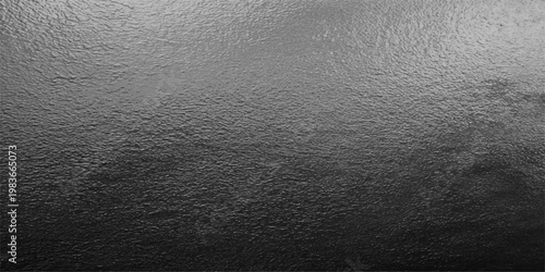 Textured metallic surface, a monochromatic shot, capturing the essence of elegance and industrial appeal. A dark texture offers depth and dimension