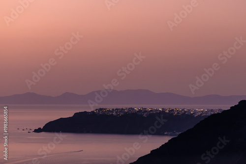 Panoramic view of Oia village on the island of Santorini Greece and an amazing orange sunset in the background
