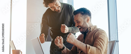 Принти на полотні Two men are showing excitement and happiness in an office