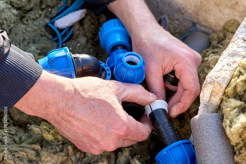 Compression ring of plastic fitting for HDPE pipes installed on end of pipe before tightening nut.
