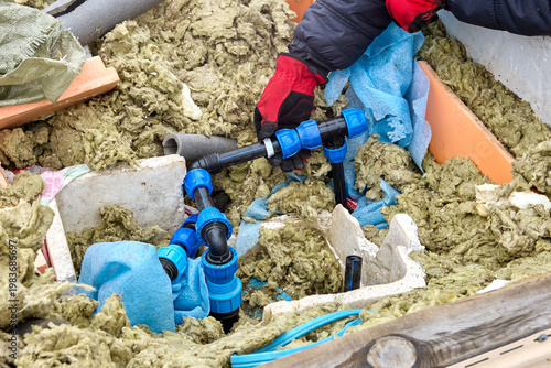 Use of plastic compression fittings for HDPE pipes during installation of distribution piping in artesian well pit.