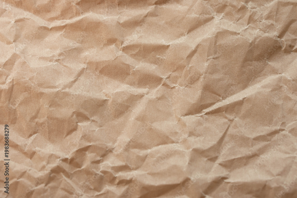 Fototapeta premium Crumpled brown kraft paper texture background with copy space. Eco, craft and packaging concept.