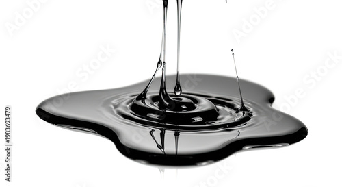 Viscous dark fluid cascading onto surface creating ripples and reflection in studio shot; glossy black liquid splashing into a pool on white background