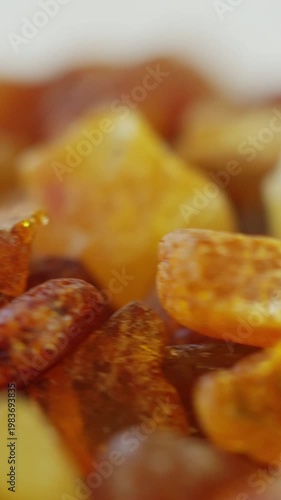 Dynamic vertical macro of fast rotating amber fragments