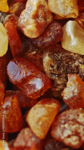 Baltic amber pieces rotating with emphasis on shape and mass