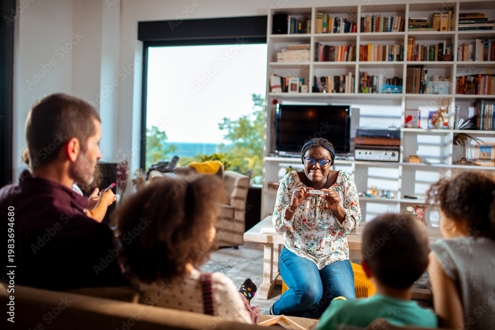 Fototapeta premium Family playing party games in cozy living room