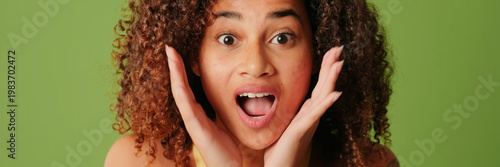 Canvas-taulu Young woman isolated on green screen chroma key background with surprise express