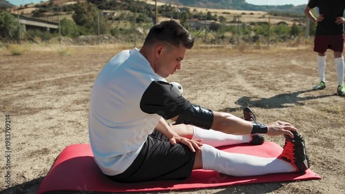 Tired Soccer Player Stretching After The Game
