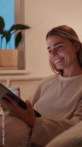 Happy Woman Relaxes At Home With Tablet And Drink