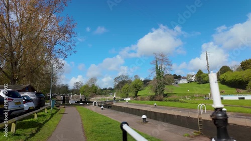 Countryside canal lock and towpath under blue sky