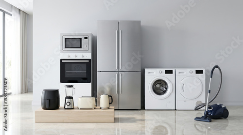 Set of modern household home appliances including stainless steel refrigerator washing machine dryer oven microwave vacuum cleaner and small kitchen electronics in a bright room