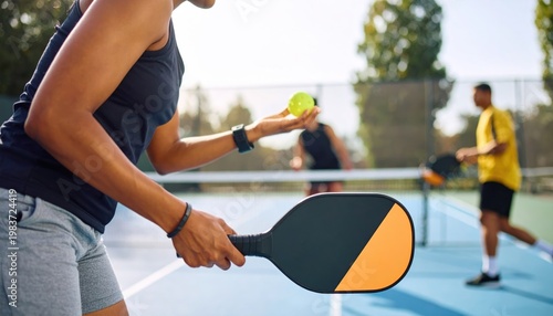 Group of People Playing Pickleball on Outdoor Court.