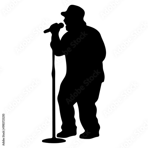 Silhouette of a singer performing on stage with a microphone.