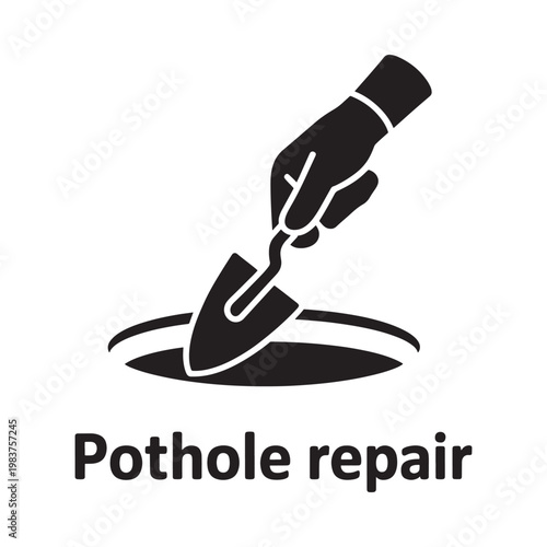 A hand using a small shovel to fill a circular pothole