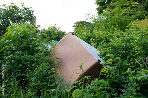Closeup of Dirty Old brown Sofa left in the forest on the side of the road in Thailand, Selective Focus.