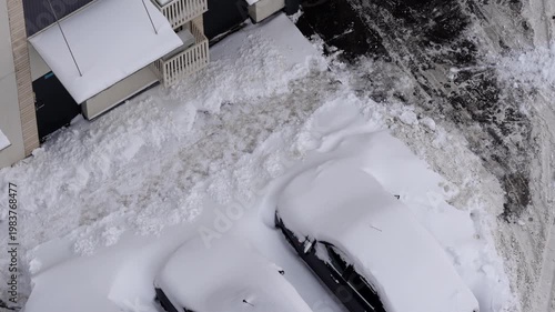 residential courtyard cars covered in snow winter snowfall top view aerial neighborhood parking snowed-in