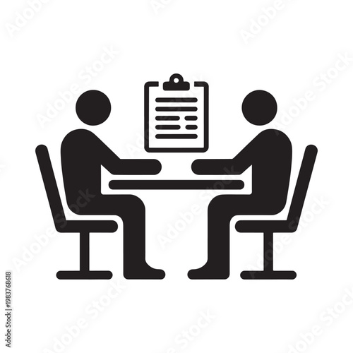 Two people sit at a table with a clipboard between them