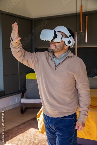 Mustard-yellow blanket is covering low-profile daybed near copper pendant lights, sunlight patch