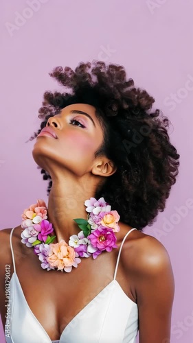 Elegance and confidence: woman wearing floral necklace against pink background