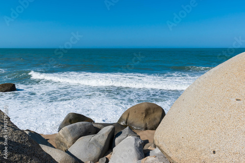 Exotic beach landscape with large granite rocks, and bright aquamarine water