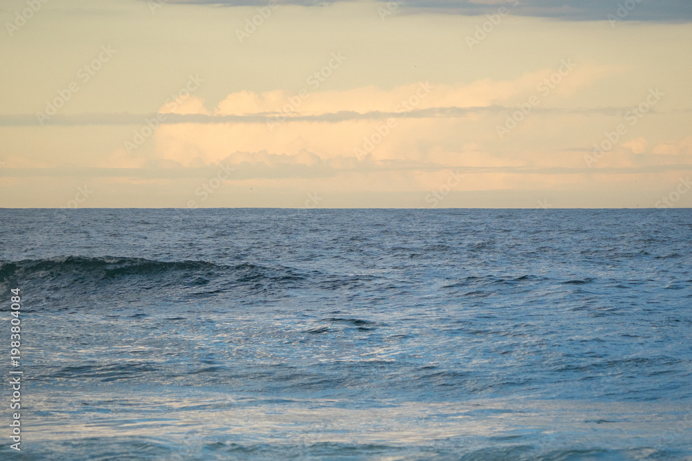 Fototapeta premium Sunset over the sea with soft glowing sky