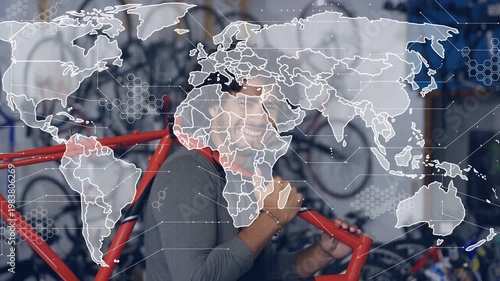 Bike tech lifting red frame, shouldering, inspecting for repair while world map hex overlay growing