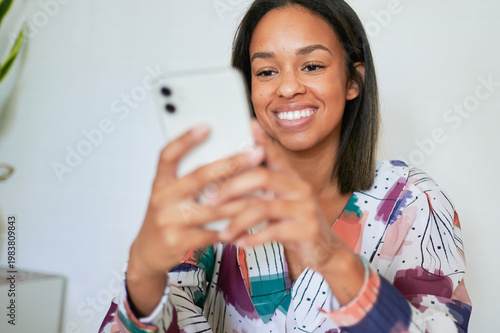 Woman smiling and using mobile phone