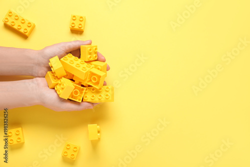 Woman holding plastic build...