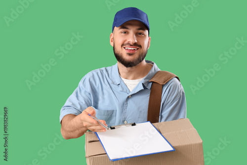 Handsome postman with clipb...