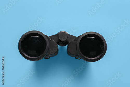 Modern binoculars on blue b...