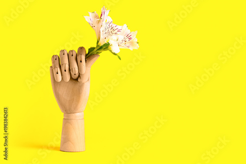 Wooden hand with flowers on...