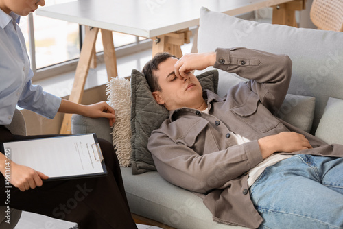Male drug addict lying on sofa at psychologist's office