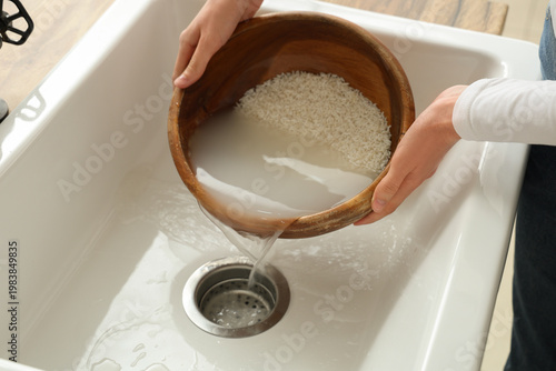 Woman pouring water into si...