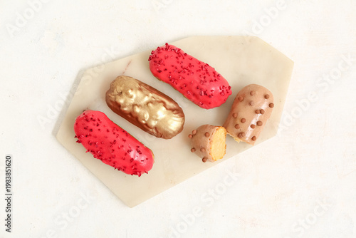 Sweet eclairs on light  background