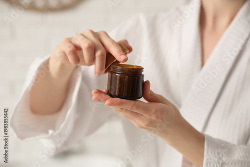 Young woman applying cosmet...