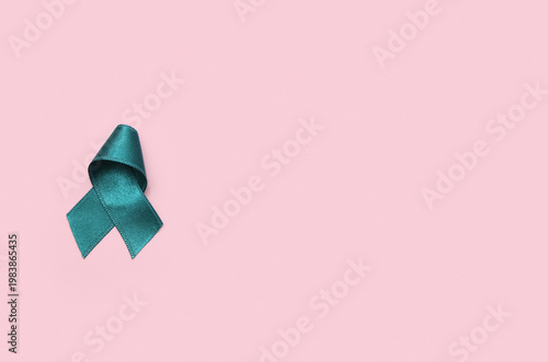 Teal ribbon on pink backgro...